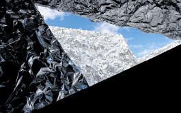 Close up of Aluminati installation in Reykjavik. Geometric layers of crumpled aluminum form an opening showing blue sky with light clouds. 