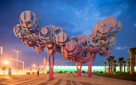 Plaza at nightfall with at its center the 'South of the Clouds' installation designed by Ballistic Architecture Machine. 